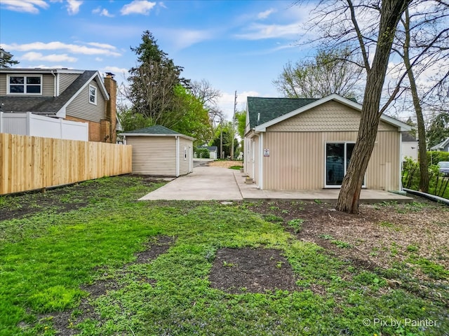 view of yard featuring a patio area and an outdoor structure