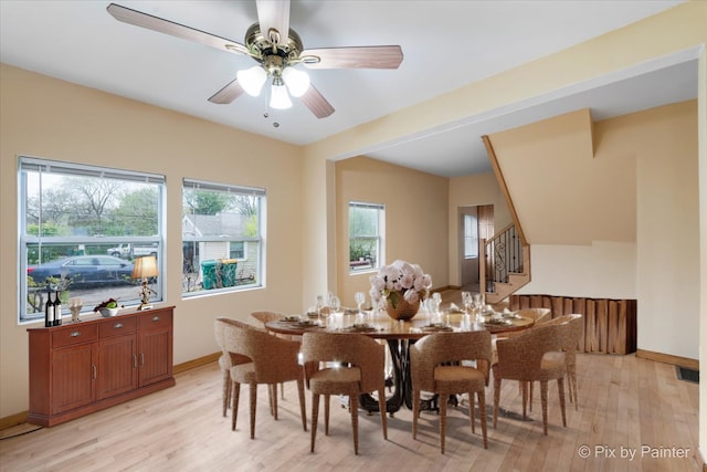 dining area with ceiling fan and light hardwood / wood-style flooring