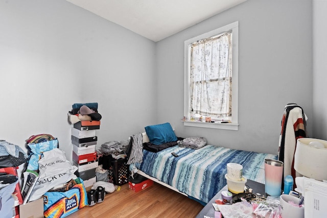 bedroom with hardwood / wood-style flooring