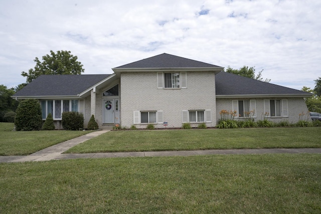 tri-level home with a front lawn