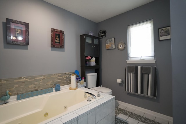 bathroom featuring tile patterned floors, a relaxing tiled tub, and toilet