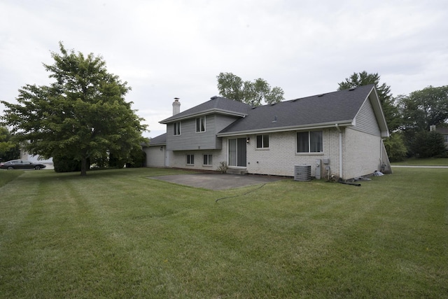 back of property featuring a lawn, cooling unit, and a patio