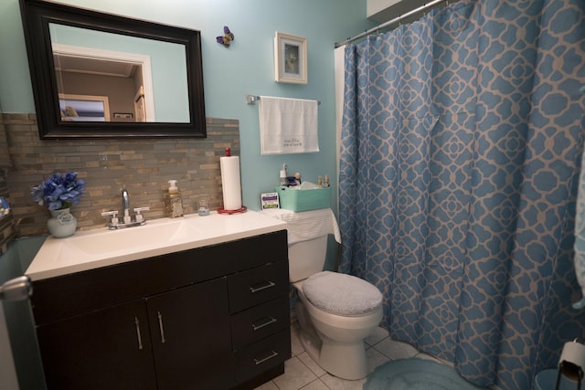 bathroom with vanity, backsplash, tile patterned flooring, toilet, and walk in shower