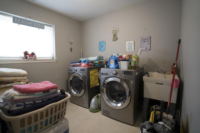 washroom featuring washer and dryer and sink