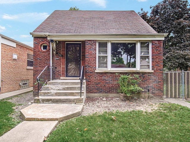 bungalow-style home with a front lawn