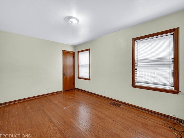 empty room with light hardwood / wood-style flooring