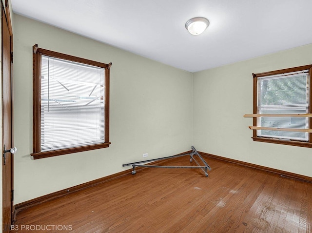 empty room featuring hardwood / wood-style flooring and plenty of natural light