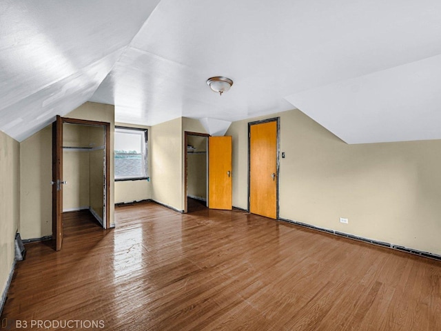 additional living space with dark hardwood / wood-style floors and lofted ceiling