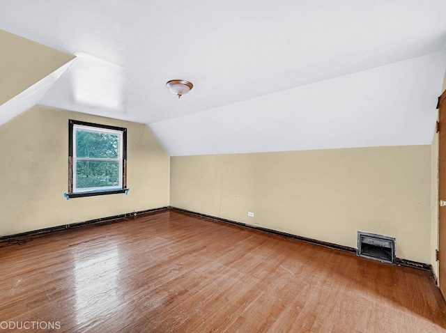 bonus room featuring hardwood / wood-style flooring and lofted ceiling