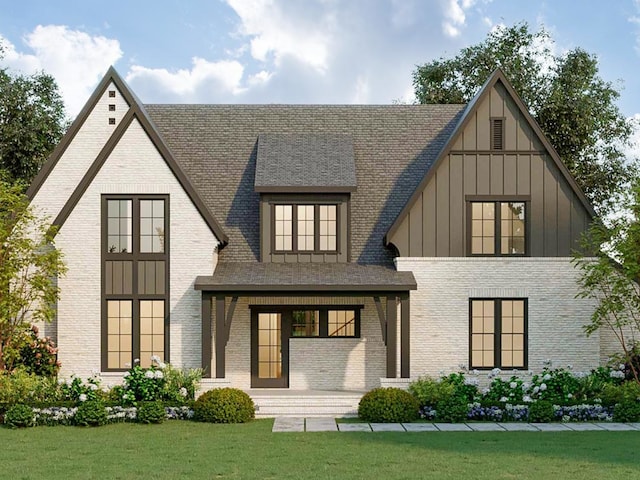 back of property with board and batten siding, roof with shingles, a lawn, and brick siding