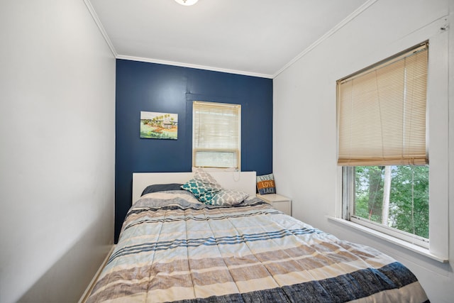 bedroom with ornamental molding and baseboards