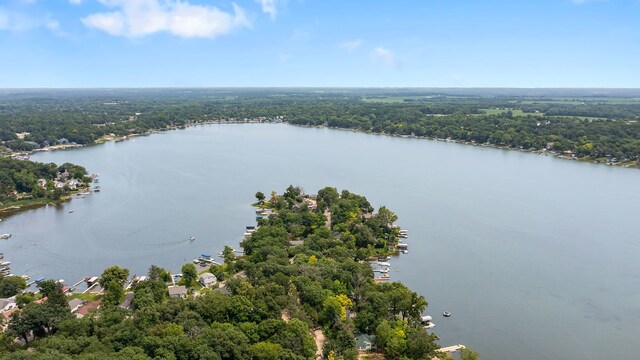 aerial view featuring a forest view and a water view