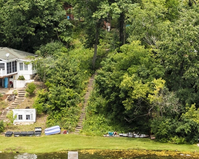 drone / aerial view featuring a forest view