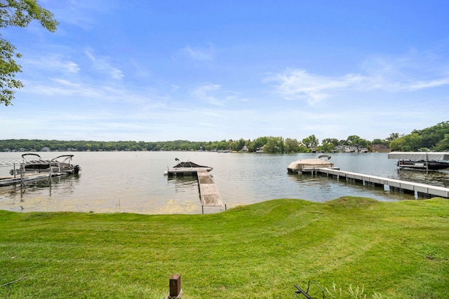 dock area with a water view and a lawn