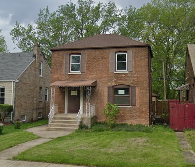10840 S Buffalo Ave, Chicago, IL 60617 - view of front of house with brick siding and a front lawn