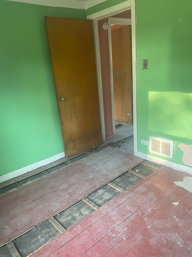 10840 S Buffalo Ave, Chicago, IL 60617 - unfurnished room featuring hardwood / wood-style floors, baseboards, and visible vents