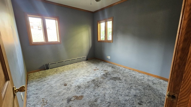 carpeted spare room featuring a baseboard radiator, crown molding, and baseboards