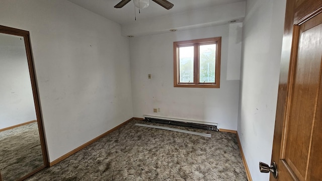 carpeted spare room featuring a baseboard heating unit, ceiling fan, and baseboards