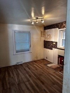 kitchen with rail lighting and dark hardwood / wood-style floors