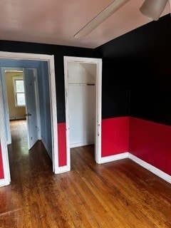 unfurnished bedroom with hardwood / wood-style floors and a closet