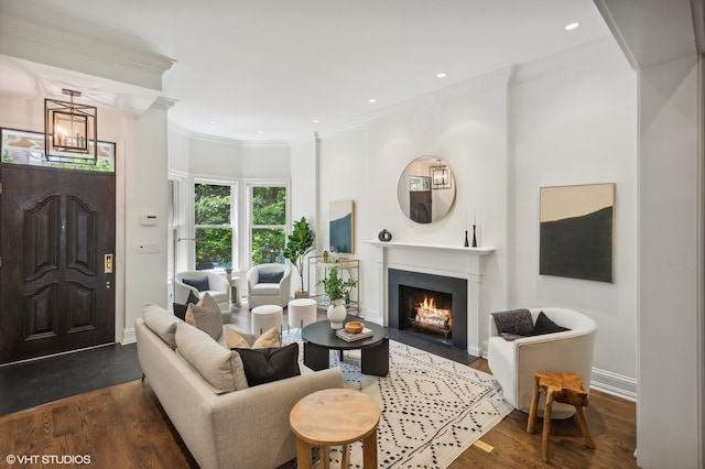 living room with an inviting chandelier, crown molding, and dark hardwood / wood-style floors