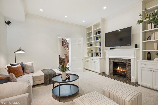 carpeted living room featuring built in shelves and ornamental molding