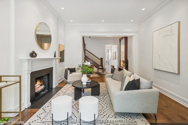 living room featuring dark hardwood / wood-style floors and ornamental molding