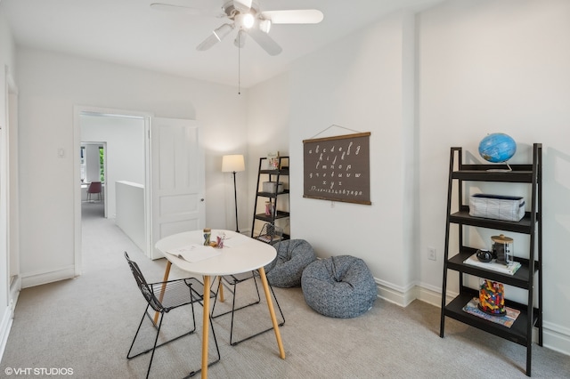 dining area featuring light colored carpet and ceiling fan