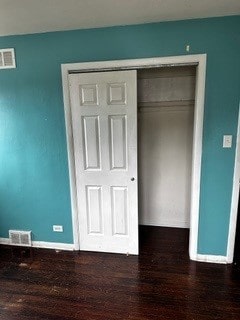 unfurnished bedroom featuring hardwood / wood-style flooring and a closet