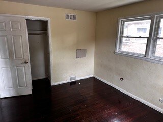 unfurnished bedroom featuring hardwood / wood-style flooring and a closet