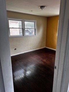 empty room with hardwood / wood-style floors