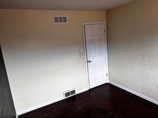 empty room with hardwood / wood-style flooring