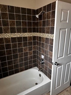 bathroom featuring tiled shower / bath combo and tile patterned floors