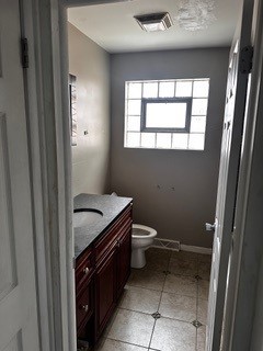 bathroom featuring tile patterned floors, vanity, and toilet