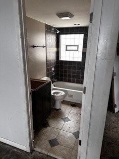 full bathroom with vanity, toilet, tiled shower / bath combo, and tile patterned flooring