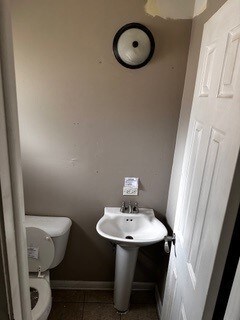 bathroom with toilet and tile patterned flooring