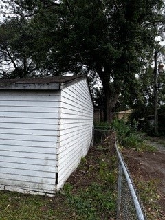 view of side of home with a shed