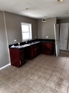 kitchen with light tile patterned flooring and sink