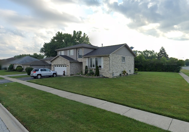 view of front of house with a front yard and a garage