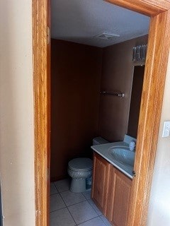 bathroom featuring tile patterned floors, vanity, and toilet