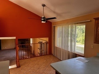 interior space featuring ceiling fan, tile patterned floors, and vaulted ceiling