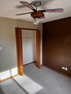 unfurnished bedroom with carpet, a closet, and ceiling fan