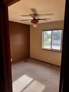 carpeted empty room with ceiling fan