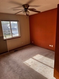 spare room with ceiling fan and carpet