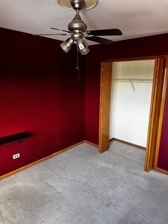 unfurnished bedroom with ceiling fan, light carpet, and a closet