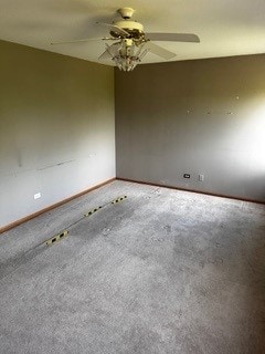 spare room featuring ceiling fan and carpet