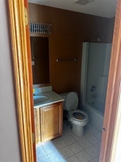 full bathroom with tile patterned floors, shower / bathtub combination, vanity, and toilet