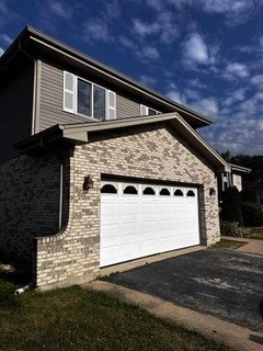 view of side of home with a garage