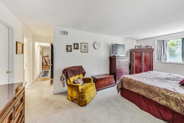 bedroom featuring light colored carpet