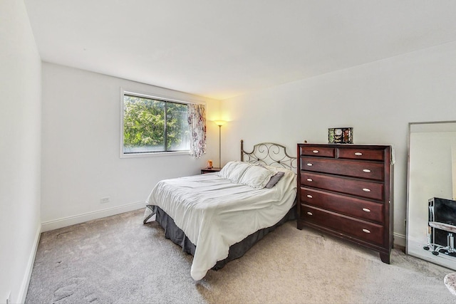 bedroom with light colored carpet